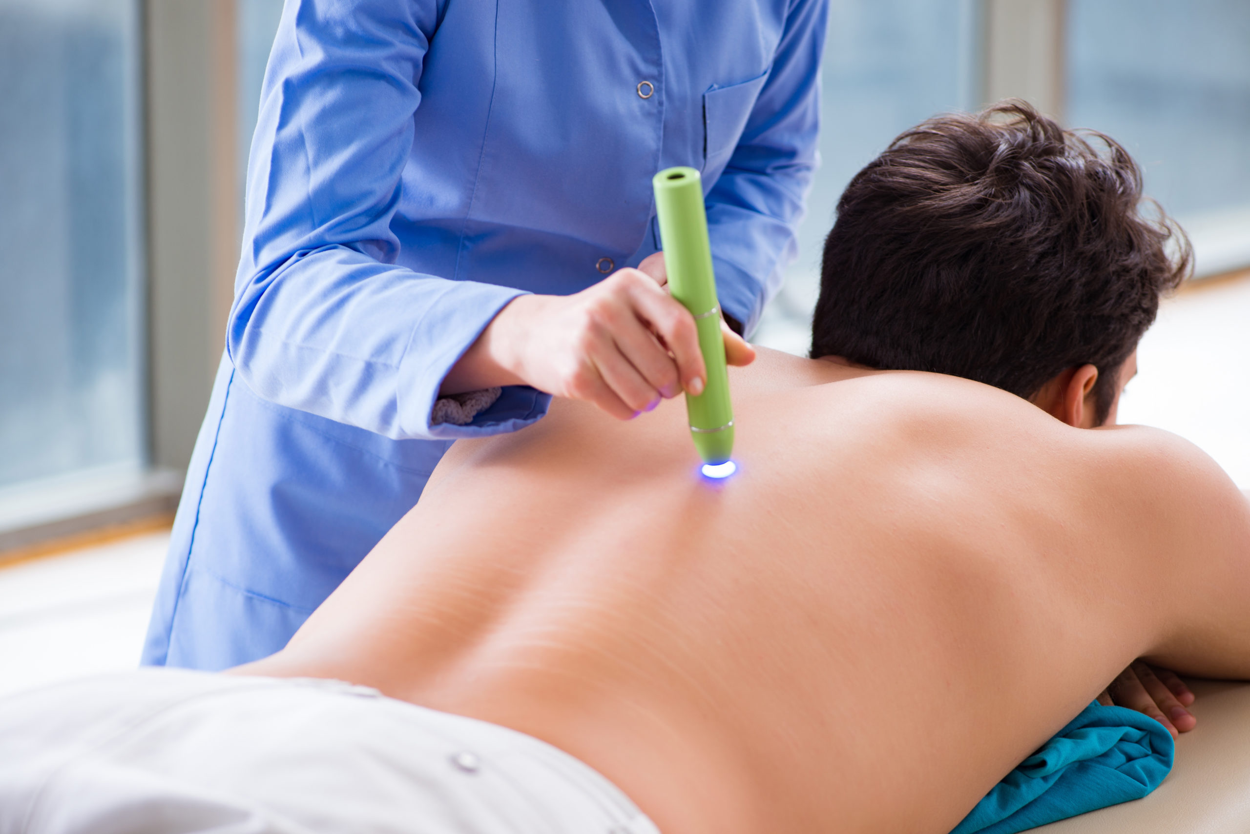 Patient in clinic undergoing laser scar removal